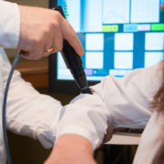 Foto einer SpineLiner-Therapiesitzung am Ellenbogen mit Blick auf den Therapiemonitor in der Orthopädiepraxis am Lambertiplatz in Lüneburg